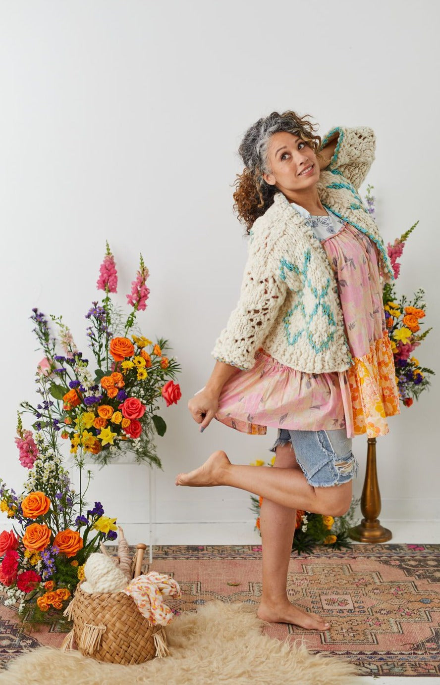 Model showing off front panel and sleeve of High Fives Cardi