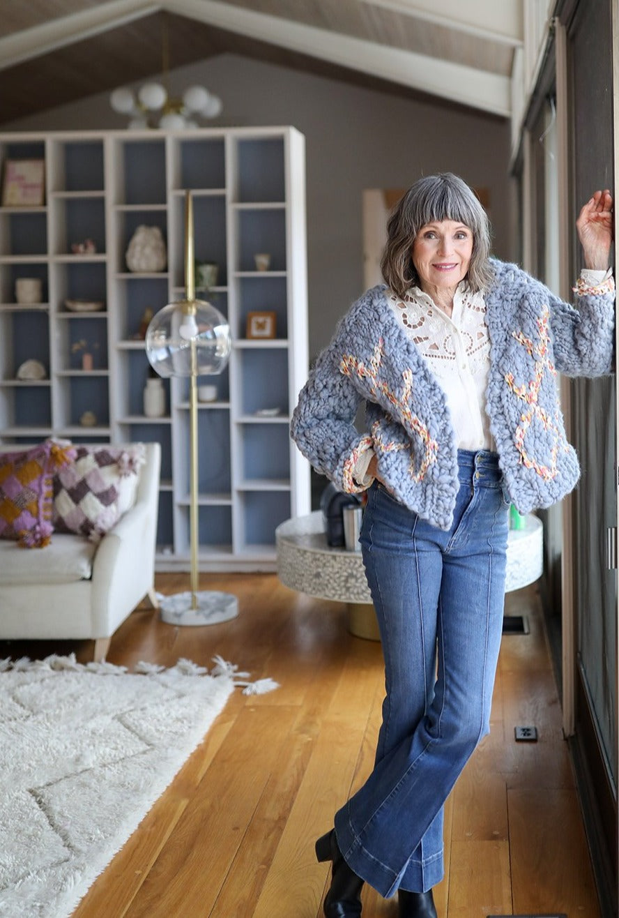 Model wearing High Fives Cardi in Breezy Blue and Ochre Rose yarns