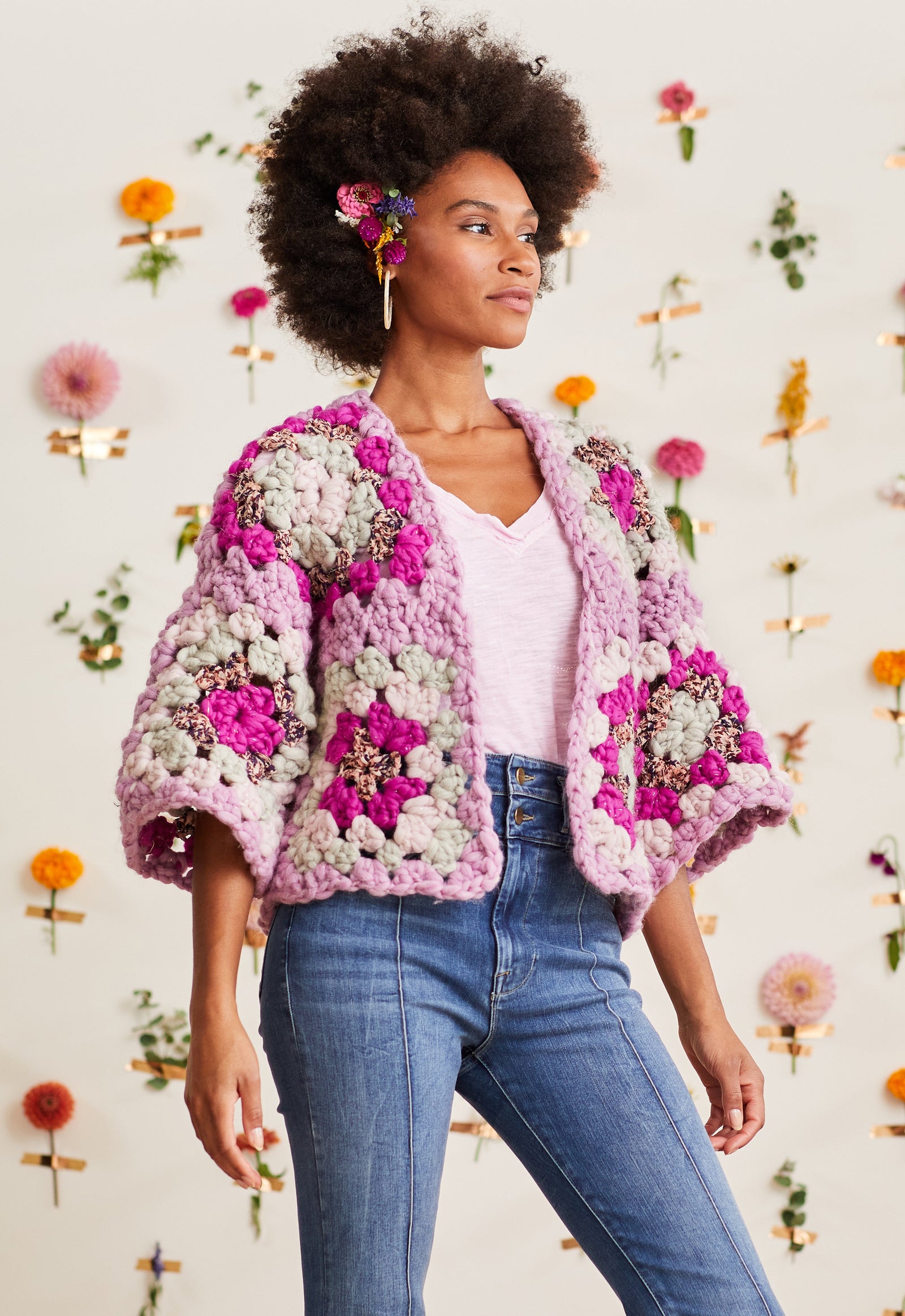 Model wearing crochet cardi displaying granny square sleeves