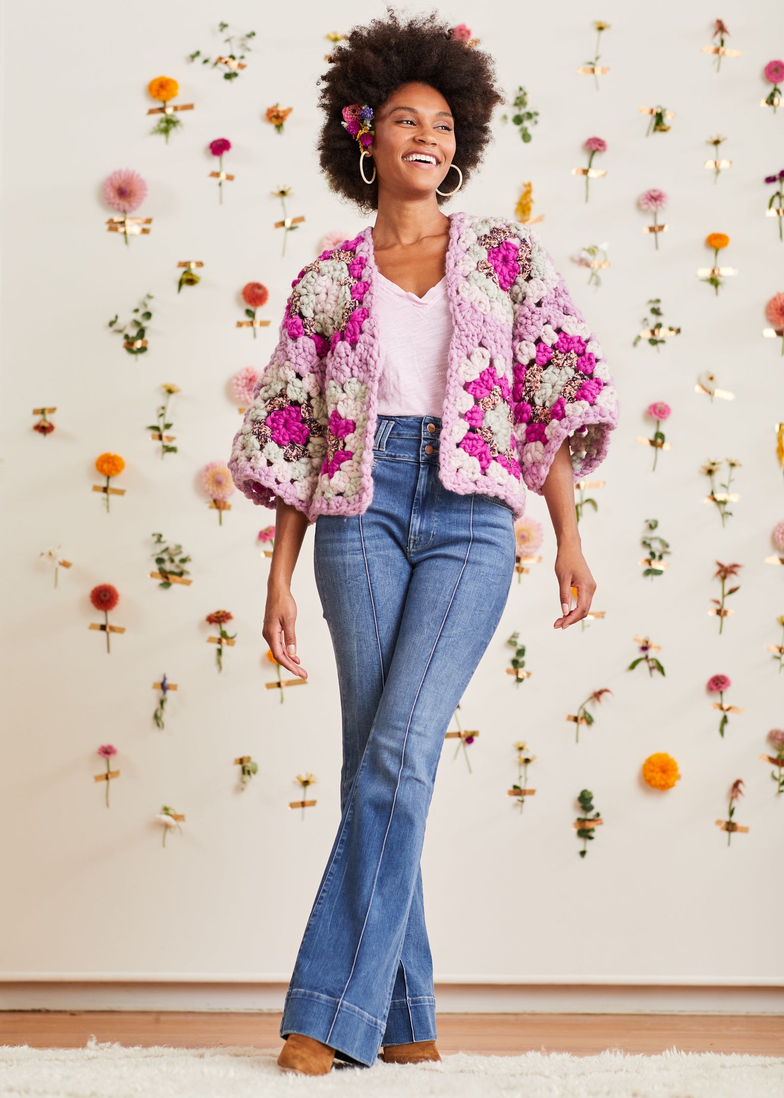 Model wearing oversized, boxy crochet cardigan with mid-length robe sleeves