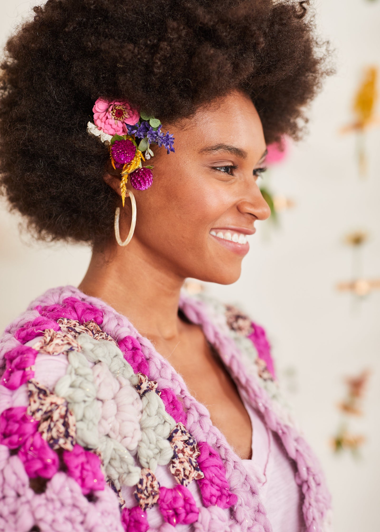 Close-up of granny square shoulder and crochet neckline edging on model