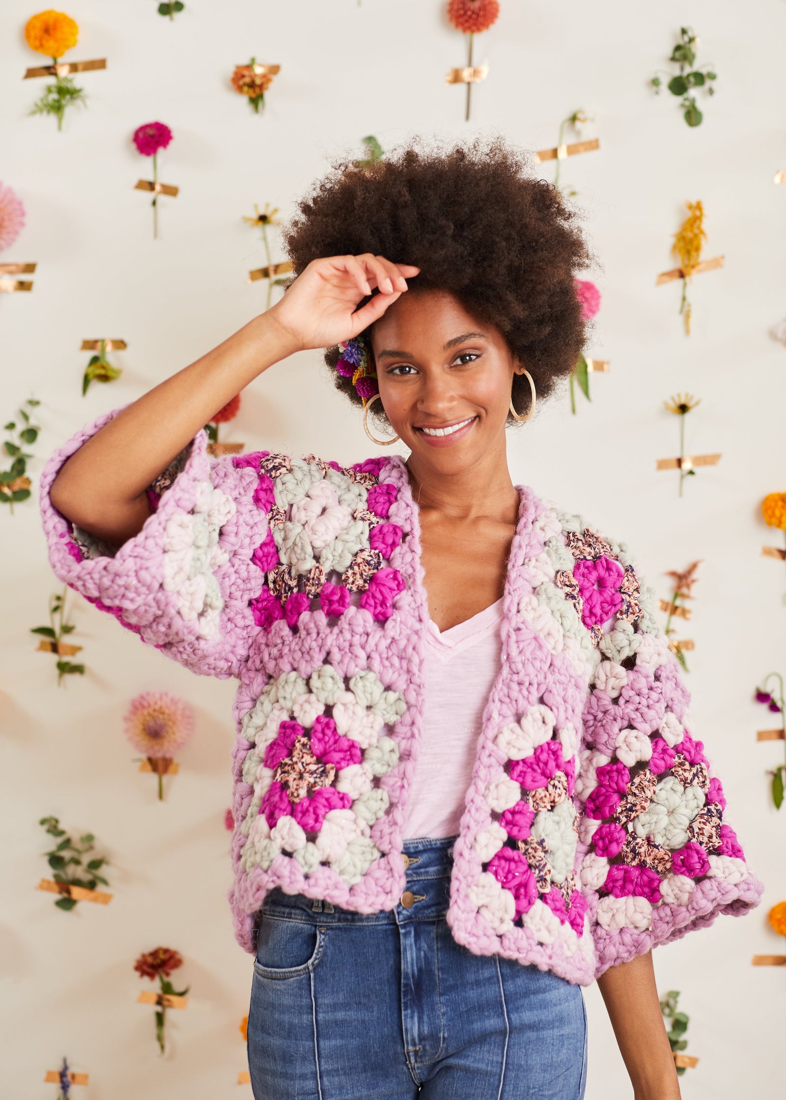 Model lifting one arm upward to show front of cardi and sleeve underarm