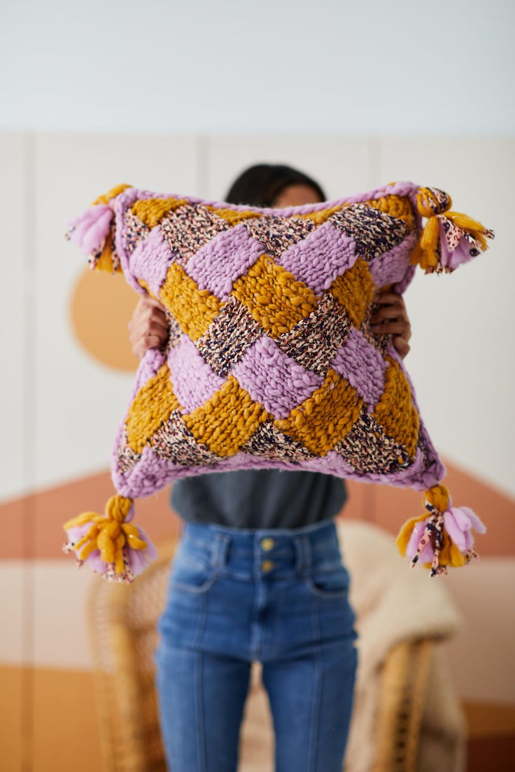 Model holding entrelac pillow.