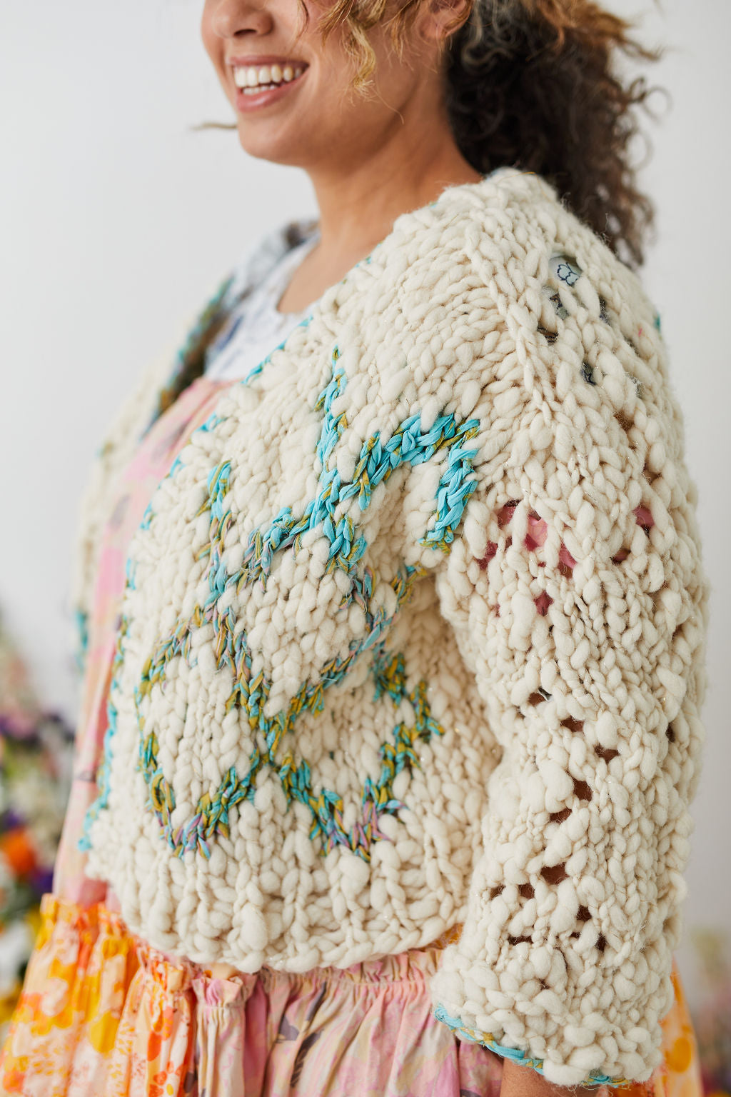 Front Panel detail shot of High Fives Cardi in French Vanilla and Reflection Pool yarns