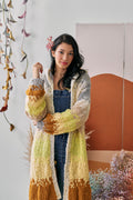 Model posing with one hand up wearing the Soulshine Cardi