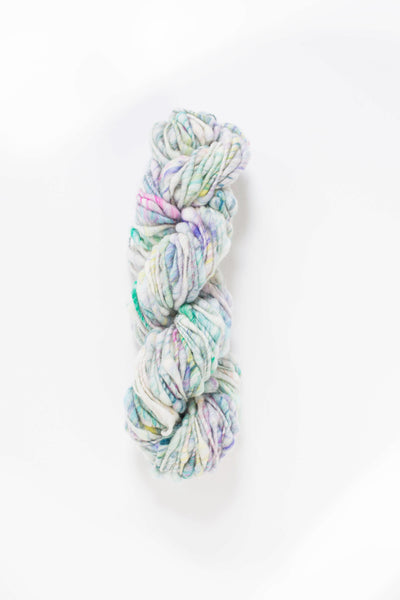 thick-and-thin, core-spun wool yarn with an ivory base and a hand-carded melange of blues, greens, pinks and purples