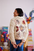 Model displaying  multicolored granny square hexagons on back of cardigan