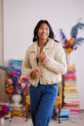 Model holding front of cardigan closed displaying wrist cuff ribbing