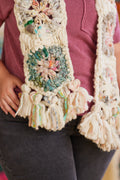 Crochet multicolored hexagon close-up featuring variety of yarns and tassels