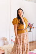Model wearing marigold boucle knit cardigan with short puff sleeves