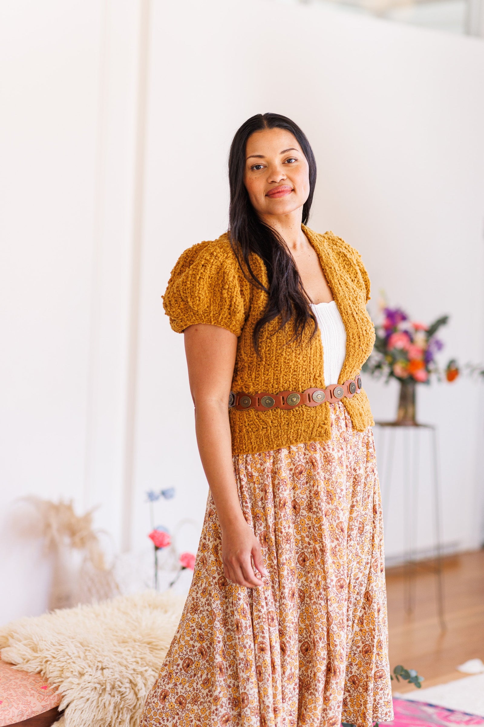 Model wearing marigold boucle knit cardigan with short puff sleeves