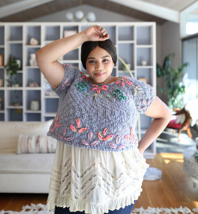 Second model smiles for the camera with a different sweater
