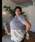 Model standing while posing wearing the sweater