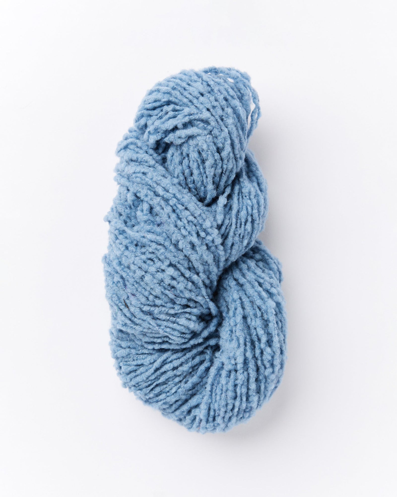 A brushed boucle yarn in a dusty denim blue color