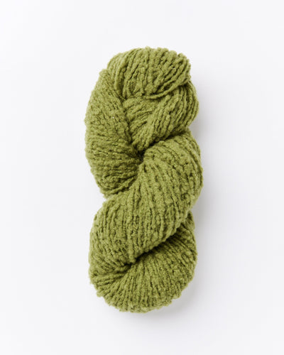 A skein of brushed boucle yarn in an olive green color.