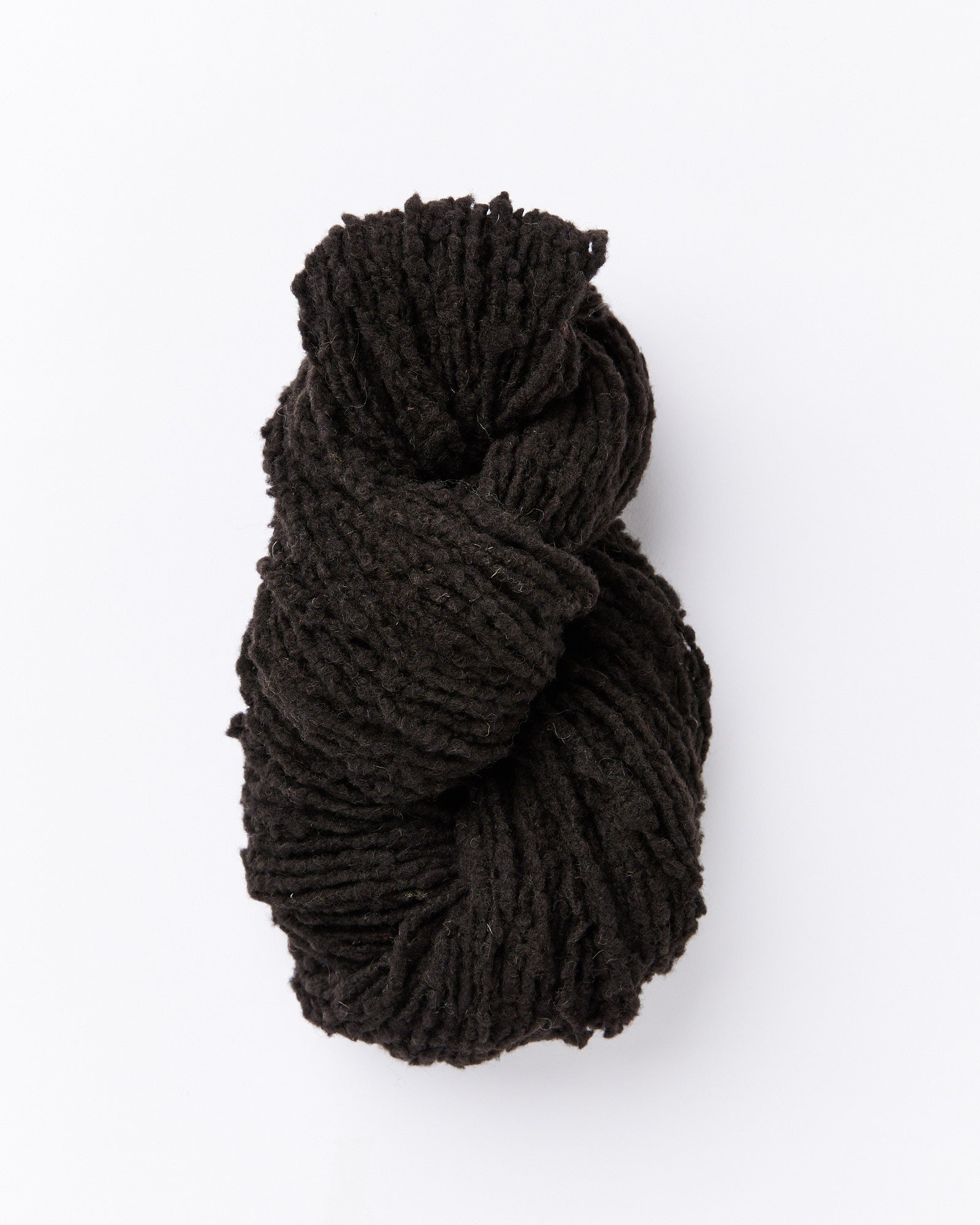 A brushed boucle yarn in a dark charcoal grey almost true black color.
