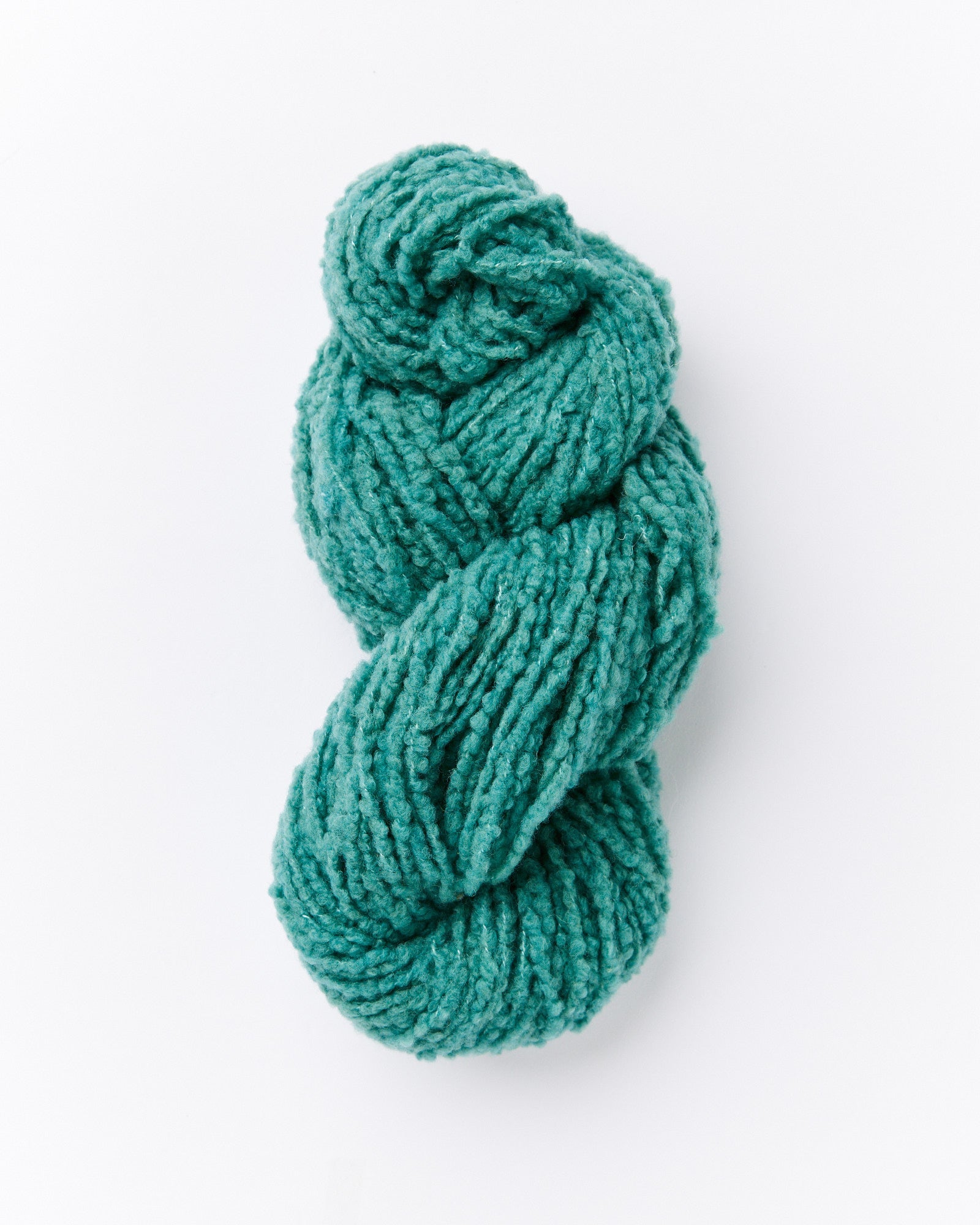 A brushed boucle yarn in a pine green color with blue undertones
