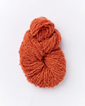 A brushed boucle yarn in a burnt orange color.