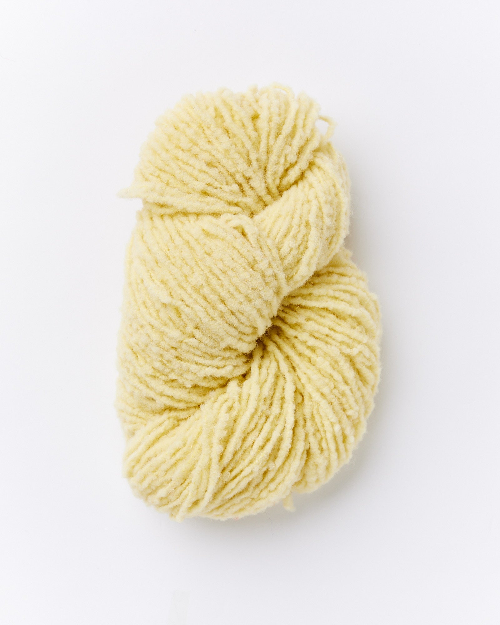 A brushed boucle yarn in a butter yellow color.