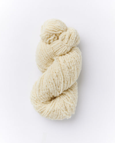 A skein of brushed boucle yarn in ivory white