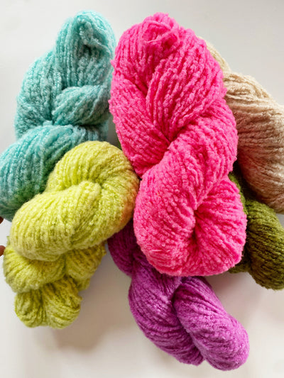 Skeins of brushed boucle yarn in a mix of bright colors