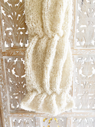 a photo of a scarf knit in a brushed boucle yarn in an ivory color, included to show the texture of the stitches