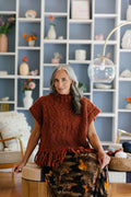 Seated model in cozy handknit Provence Poncho