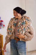 Wool cardigan with multicolored fringe collar worn with floral top and denim jeans