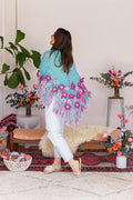 Model twisting to show back of wool shawl