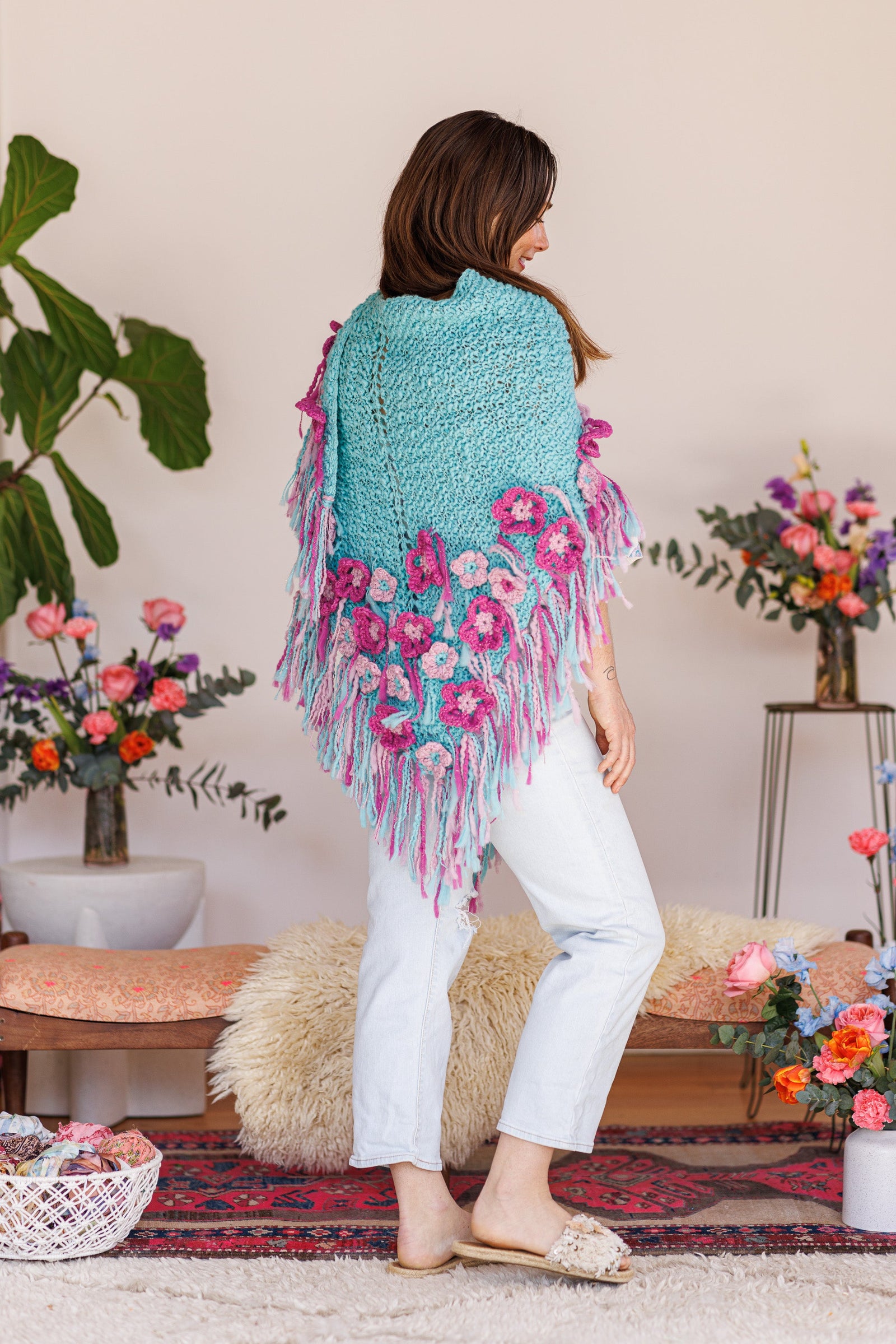 Back of model with one side of shawl wrapped over shoulder to hold shawl in place around body