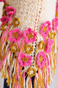 Close-up of crochet flowers and fringe attached to knit shawl