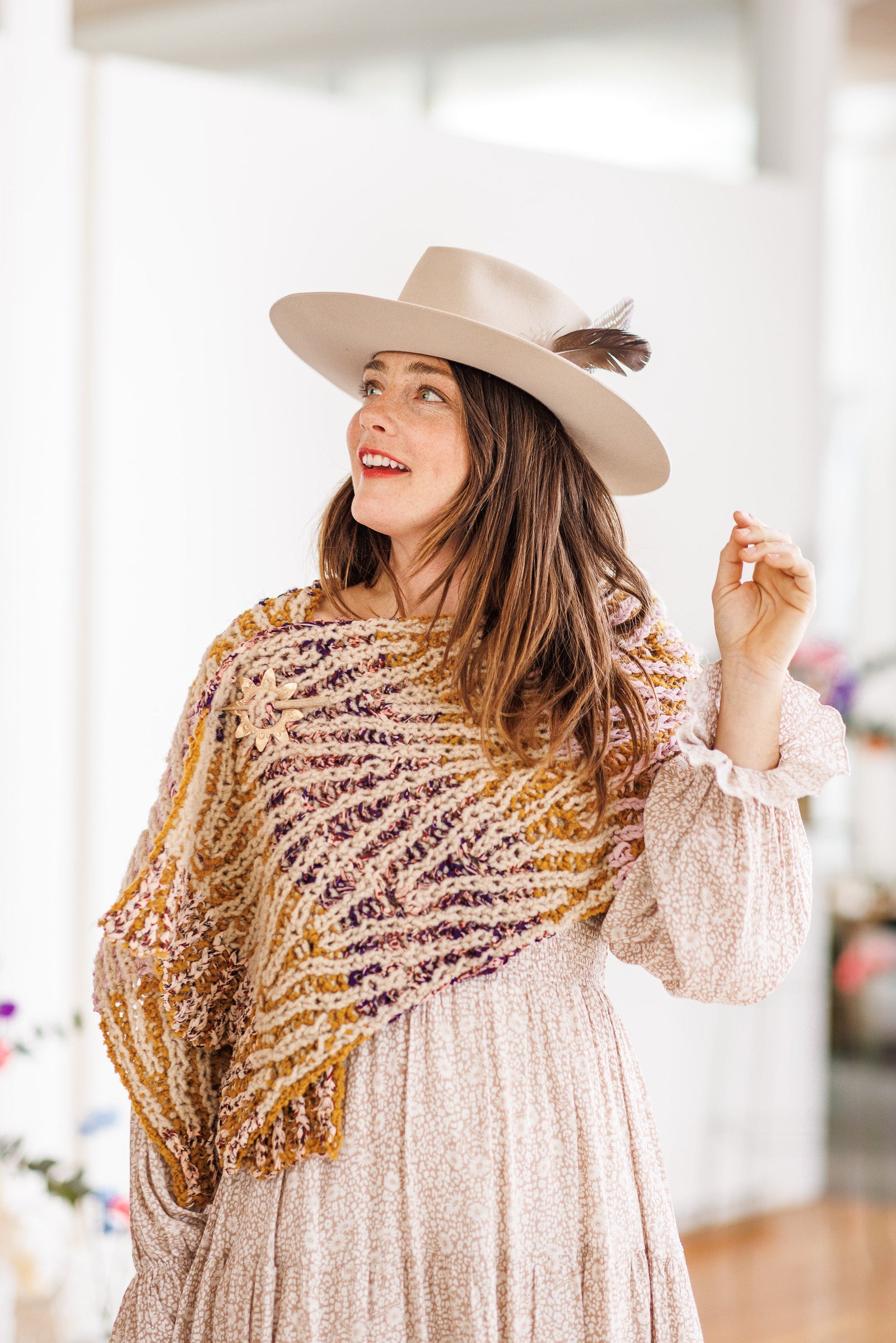 Knit wrap with lace detail is worn over a long sleeve dress