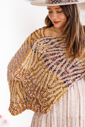 Model shows wavy edge detail on both ends of brioche knit wrap