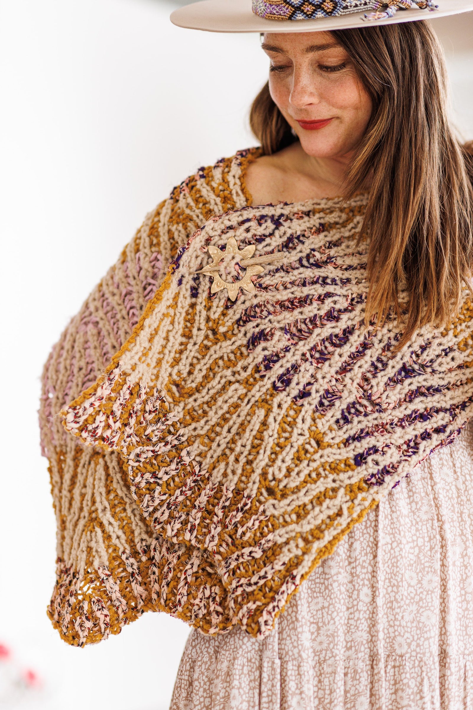 Model shows wavy edge detail on both ends of brioche knit wrap