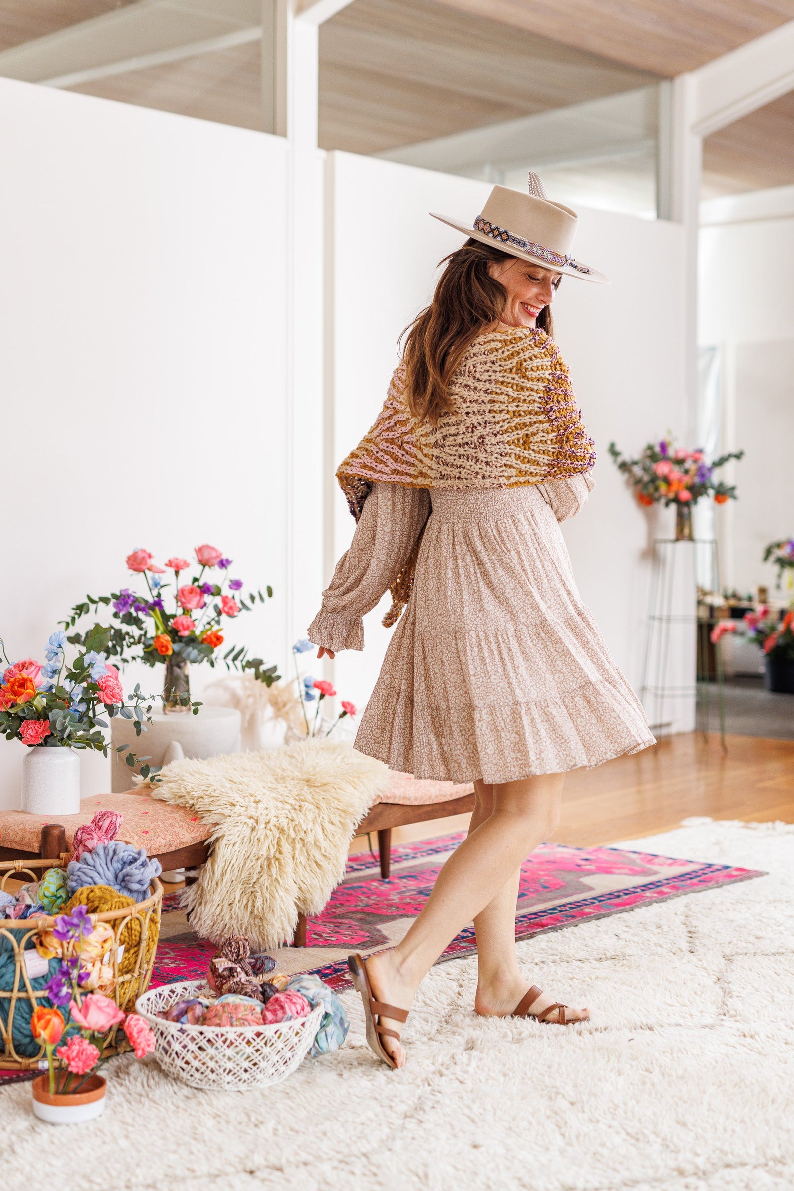 Model twists to show knit wrap across upper back and shoulders