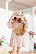Model adjusts hat as wrap remains on shoulders, displaying wavy design feature at ends of wrap