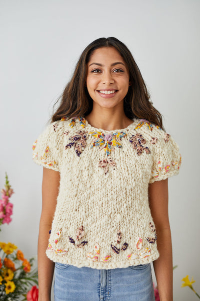 Model smiles for the camera while wearing the Embroidered Sweater