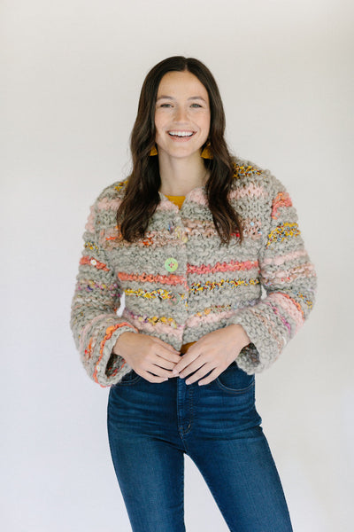 Model smiling wearing striped cardi.