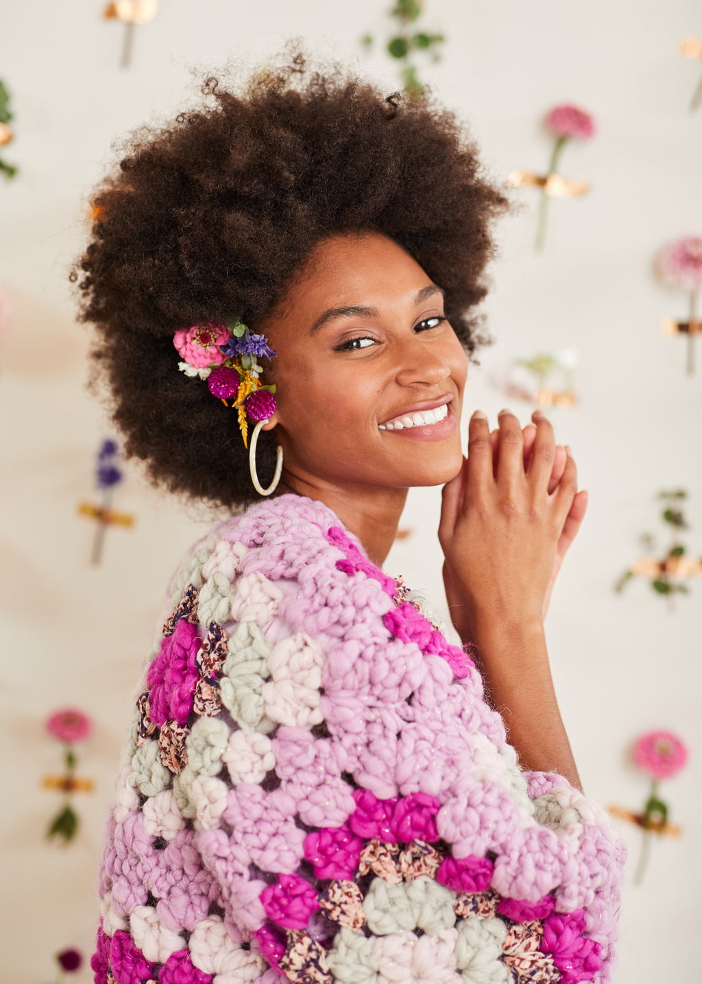 Close-up of orchid crochet cardi shoulder on smiling model