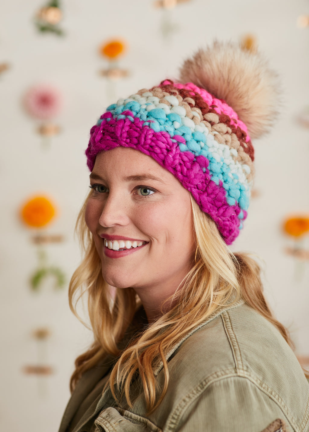 Model smiling at the camera while wearing the Over Rainbow Hat