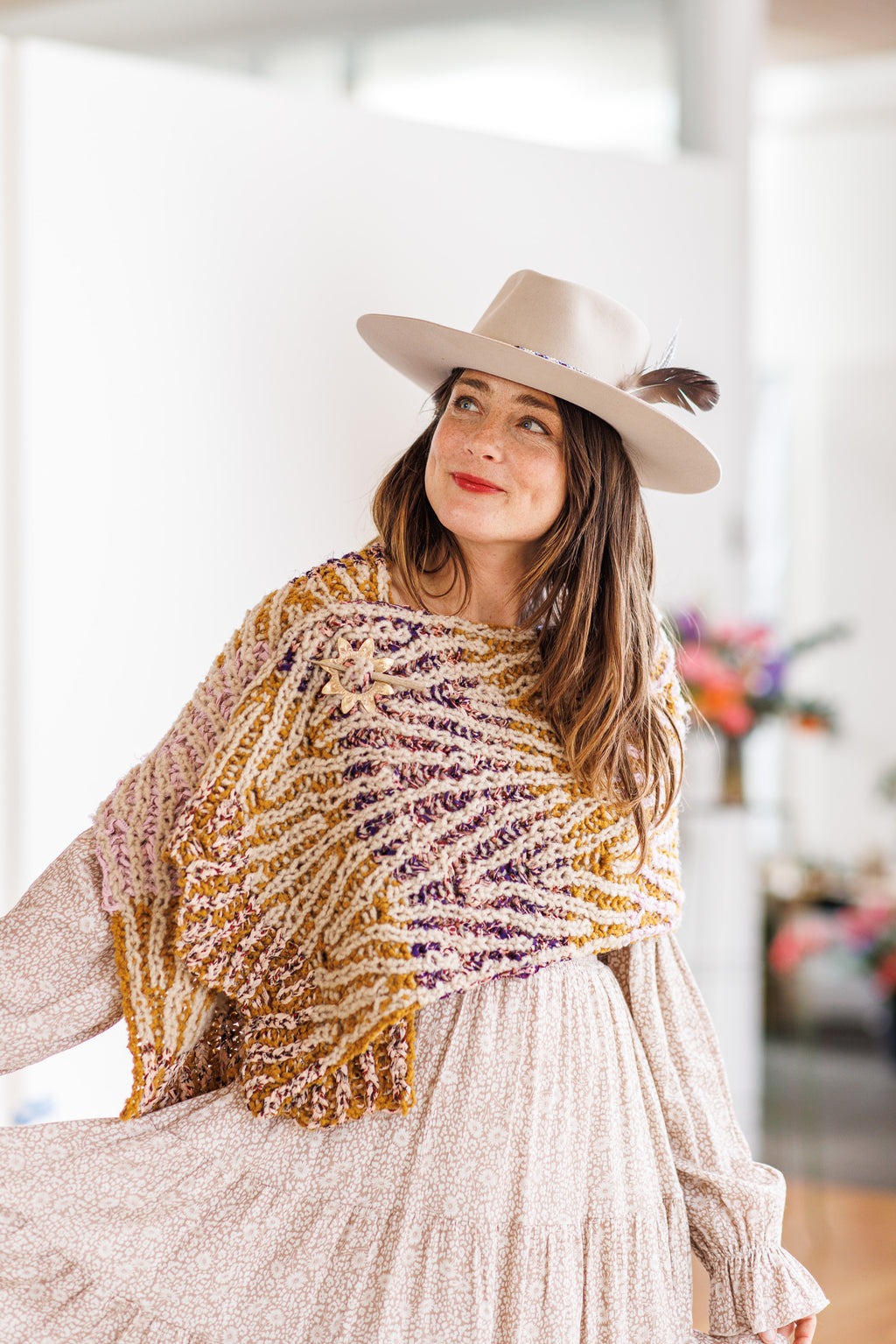 Model wearing 5 color knit wrap across upper body